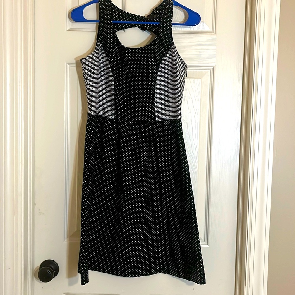 Great little black dress. Limited size 4. Polka dot design. Cutout in back.